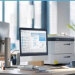 A computer monitor on a desk in an office, highlighting an enterprise fax service setup.